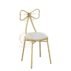 Charming gold stainless steel wedding chair featuring a romantic bow-tie laser-cut backrest, decorative seating for bridal showers