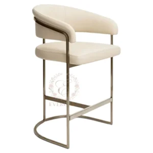 Contemporary bar stool with soft cream white upholstery and stylish curved backrest, supported by a sleek gold metal frame. Ergonomic comfort, ideal for wedding bars, bridal showers, hotel event spaces and banquet setups.