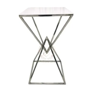Contemporary cocktail table with a unique cross-brace metal frame and a clean white top. Lightweight yet durable, perfect for wedding parties, outdoor events, pop-up bars and casual receptions.