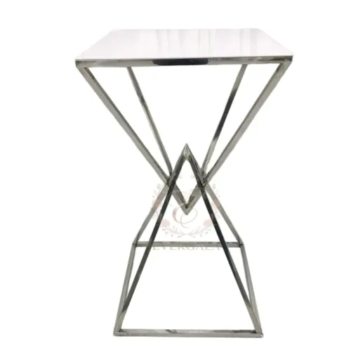 Contemporary cocktail table with a unique cross-brace metal frame and a clean white top. Lightweight yet durable, perfect for wedding parties, outdoor events, pop-up bars and casual receptions.