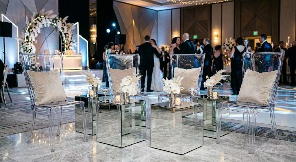 Clear acrylic ghost chairs with mirrored side tables setup near dance floor for luxury wedding lounge